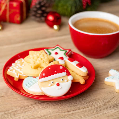 Merry Christmas with homemade cookies and coffee cup on wood table background. Xmas eve, party, holiday and happy New Year conceptの写真素材