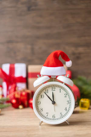 Merry Christmas with Vintage alarm clock and Xmas decoration on wooden table. party, holiday and boxing day conceptの写真素材