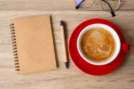 blank notebook and coffee cup on wood table. Motivation, Resolution, To do list, Strategy and Plan conceptの写真素材