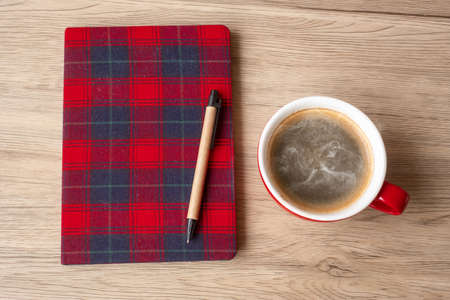 Blank notebook, coffee cup and pen on wood table. Happy New Year, Goals, Resolution, To do list, Strategy and Plan conceptの写真素材