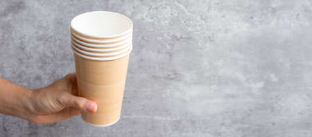Eco friendly food packaging or takeaway coffee cup. Hand holding natural container for to go. zero waste, pollution, earth day, free plastic, world Environment day conceptの写真素材
