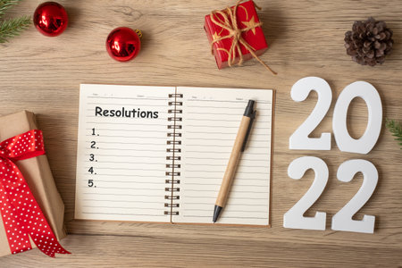 2022 Resolutions with notebook, Christmas gift and pen on wood table. Xmas, Happy New Year, Goals, To do list, start, Strategy and Plan conceptの写真素材