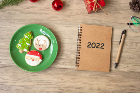 2022 notebook, black, Christmas cookies and pen on wood table, Top view and copy space. Xmas, Happy...