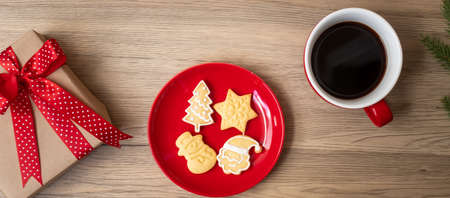 Merry Christmas with homemade cookies and coffee cup on wood table background. Xmas eve, party, holiday and happy New Year conceptの写真素材