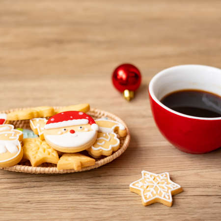 Merry Christmas with homemade cookies and coffee cup on wood table background. Xmas eve, party, holiday and happy New Year conceptの写真素材