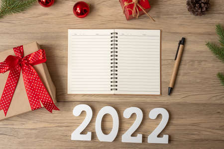 2022 New Year with notebook, Christmas gift and pen on wood table. Xmas, Happy New Year, Goals, Resolution, To do list, start, Strategy and Plan conceptの写真素材