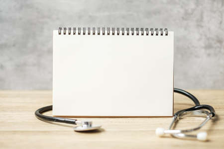 blank notebook and stethoscope for copy space your text. healthcare, Insurance, Wellness and medical conceptの写真素材