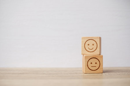 emotion face symbol on wooden blocks. mood, Service rating, ranking, customer review, satisfaction, evaluation and feedback conceptの写真素材
