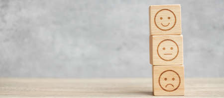 emotion face symbol on wooden blocks. mood, Service rating, ranking, customer review, satisfaction, evaluation and feedback conceptの写真素材