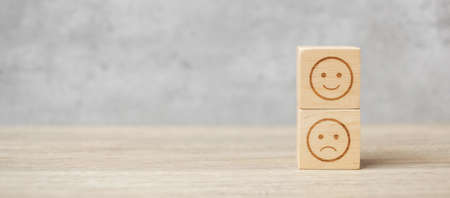 emotion face symbol on wooden blocks. mood, Service rating, ranking, customer review, satisfaction, evaluation and feedback conceptの写真素材