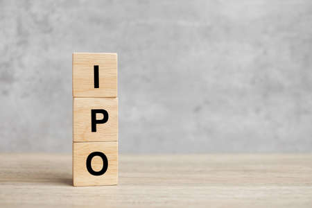 IPO (Initial Public Offering) word with wooden cube block, shares of a private corporation to the public in a new stock issuance. Stock, Fund, Investors and Investment conceptの写真素材