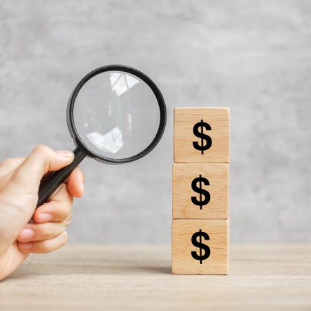 American Dollar symbol block with hand holding glass magnifying. Money, cash, currency and investment concept.の写真素材