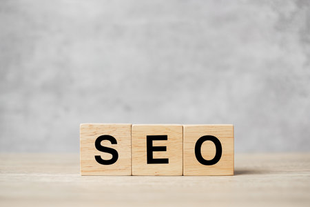 SEO (Search Engine Optimization) text wooden cube blocks on table background. Idea, Strategy, advertising, marketing, Keyword and Content conceptの写真素材
