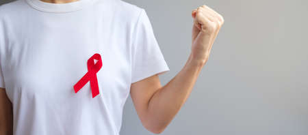 Red Ribbon for December World Aids Day (acquired immune deficiency syndrome), multiple myeloma Cancer Awareness month and National Red ribbon week. Healthcare and world cancer day conceptの写真素材