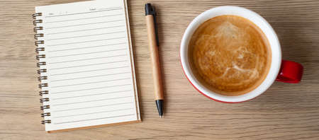 blank notebook and coffee cup on wood table. Motivation, Resolution, To do list, Strategy and Plan conceptの写真素材