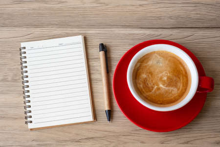 blank notebook and coffee cup on wood table. Motivation, Resolution, To do list, Strategy and Plan conceptの写真素材
