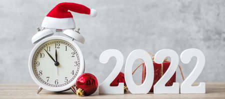 Merry Christmas with Vintage alarm clock and 2022 number on wooden table. Happy new Year, party, holiday and boxing day conceptの写真素材