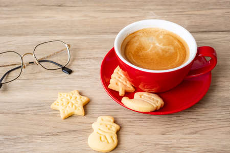 Merry Christmas with homemade cookies and coffee cup on wood table background. Xmas eve, party, holiday and happy New Year conceptの写真素材