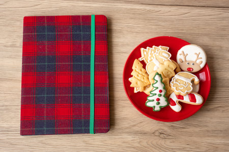 Blank notebook, Christmas cookies and pen on wood table. Xmas, Happy New Year, Goals, Resolution, To do list, Strategy and Plan conceptの写真素材
