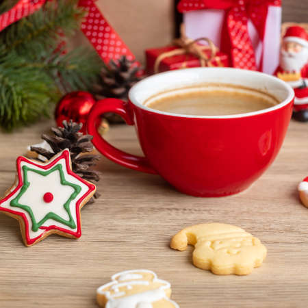 Merry Christmas with homemade cookies and coffee cup on wood table background. Xmas eve, party, holiday and happy New Year conceptの写真素材