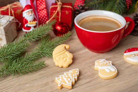 Merry Christmas with homemade cookies and coffee cup on wood table background. Xmas eve, party, holiday and happy New Year conceptの写真素材