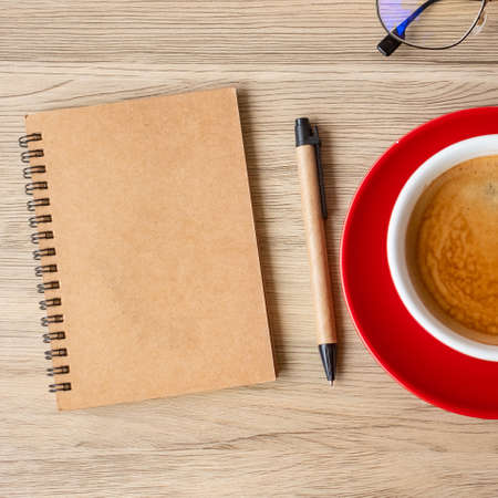 blank notebook and coffee cup on wood table. Motivation, Resolution, To do list, Strategy and Plan conceptの写真素材