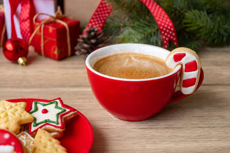 Merry Christmas with homemade cookies and coffee cup on wood table background. Xmas eve, party, holiday and happy New Year conceptの写真素材