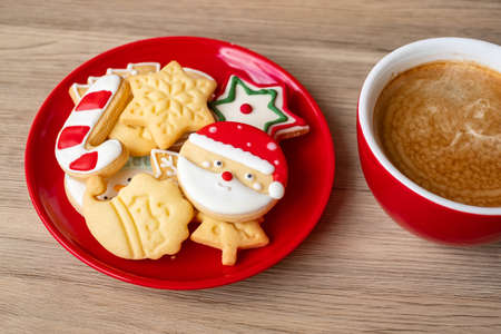 Merry Christmas with homemade cookies and coffee cup on wood table background. Xmas eve, party, holiday and happy New Year conceptの写真素材