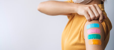 woman showing plaster after receiving covid 19 vaccine. Vaccination, herd immunity, side effect,...