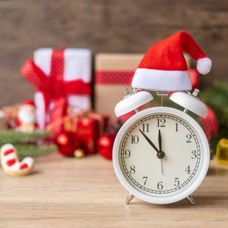Merry Christmas with Vintage alarm clock and Xmas decoration on wooden table. party, holiday and boxing day conceptの写真素材