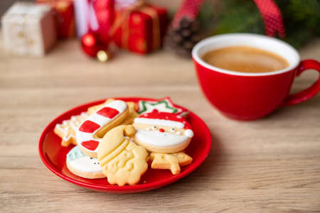 Merry Christmas with homemade cookies and coffee cup on wood table background. Xmas eve, party, holiday and happy New Year conceptの写真素材