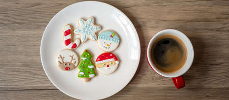 Merry Christmas with homemade cookies and coffee cup on wood table background. Xmas eve, party, holiday and happy New Year conceptの写真素材