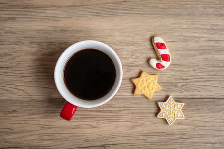 Merry Christmas with homemade cookies and coffee cup on wood table background. Xmas eve, party, holiday and happy New Year conceptの写真素材