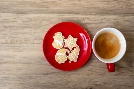 Merry Christmas with homemade cookies and coffee cup on wood table background. Xmas eve, party, holiday and happy New Year conceptの写真素材