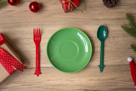 Merry Christmas with plate, fork and spoon on wood table background. Xmas, party and happy New Year conceptの写真素材