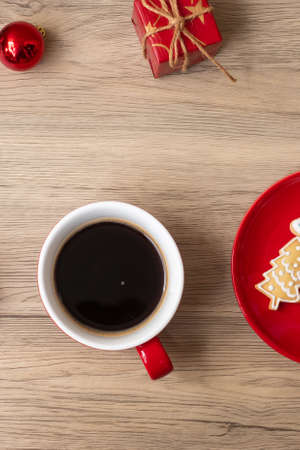 Merry Christmas with homemade cookies and coffee cup on wood table background. Xmas eve, party, holiday and happy New Year conceptの写真素材
