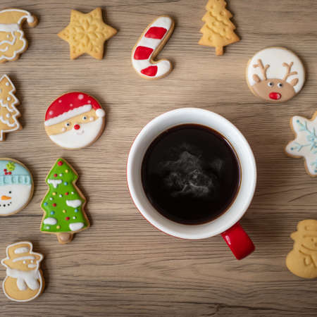 Merry Christmas with homemade cookies and coffee cup on wood table background. Xmas eve, party, holiday and happy New Year conceptの写真素材