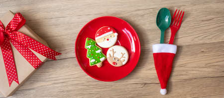 Merry Christmas with homemade cookies, fork and spoon on wood table background. Xmas, party and happy New Year conceptの写真素材