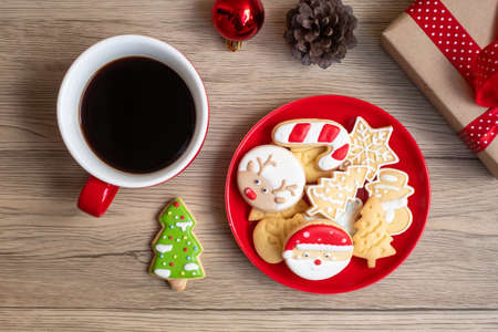 Merry Christmas with homemade cookies and coffee cup on wood table background. Xmas eve, party, holiday and happy New Year conceptの写真素材