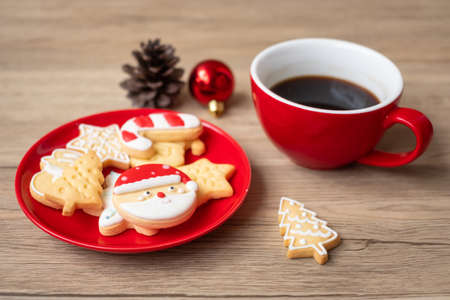 Merry Christmas with homemade cookies and coffee cup on wood table background. Xmas eve, party, holiday and happy New Year conceptの写真素材
