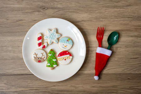 Merry Christmas with homemade cookies, fork and spoon on wood table background. Xmas, party and happy New Year conceptの写真素材