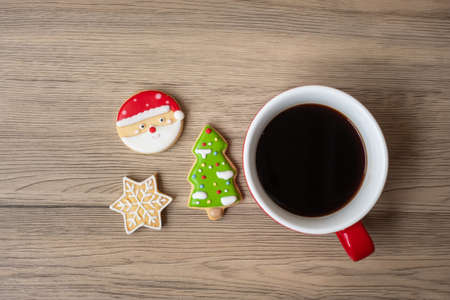 Merry Christmas with homemade cookies and coffee cup on wood table background. Xmas eve, party, holiday and happy New Year conceptの写真素材