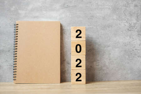 2022 Happy New Year with blank notebook and wooden number. countdown, Resolution, Goals, Plan, Action and Mission Conceptの写真素材