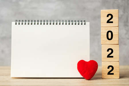 2022 cubes with red heart shape and empty notebook on table for your text. New Year, Resolution, Goal, plan, health, Love and Happy Valentine day conceptの写真素材