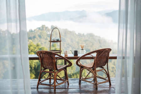 arabica coffee brewing by Vintage coffee drip equipment set on wooden table in the morning with mountain at countryside homestayの写真素材