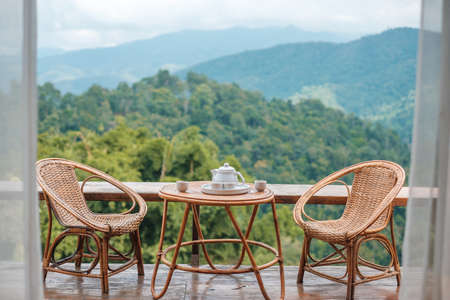 teapot set on table in the morning with mountain view at countryside home or homestay. Vacation, travel and trip conceptの写真素材