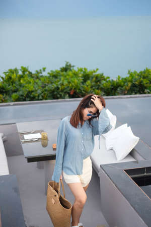 Happy woman in blue dress and sunglasses. Freedom, relaxing, vacation holiday and summer travel conceptの写真素材