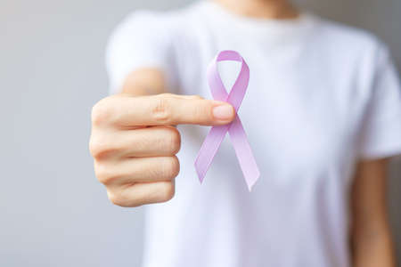 World cancer day (February 4). Woman hand holding Lavender purple ribbon for supporting people living and illness. Healthcare and medical conceptの写真素材