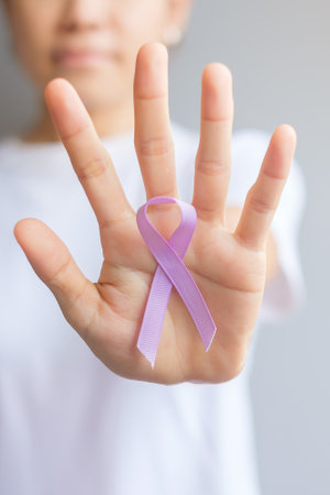 World cancer day (February 4). Woman hand holding Lavender purple ribbon for supporting people living and illness. Healthcare and medical conceptの写真素材