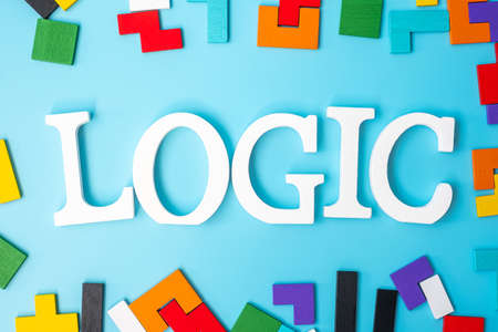 LOGIC text with colorful wood puzzle pieces, geometric shape block on blue background. Concepts of logical thinking, Conundrum, solutions, rational, strategy, world logic day and Educationの写真素材